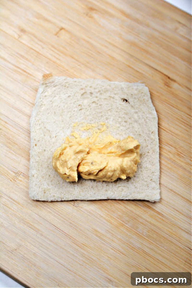 Spreading pumpkin cream cheese filling onto flattened keto bread