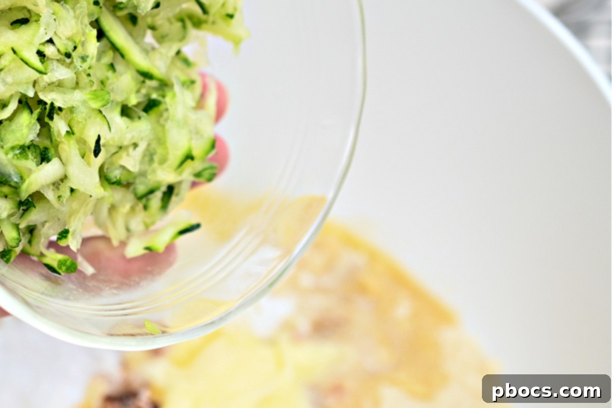 Irresistible Keto Chocolate Chip Zucchini Muffins 5 Preparing shredded zucchini for baking keto muffins