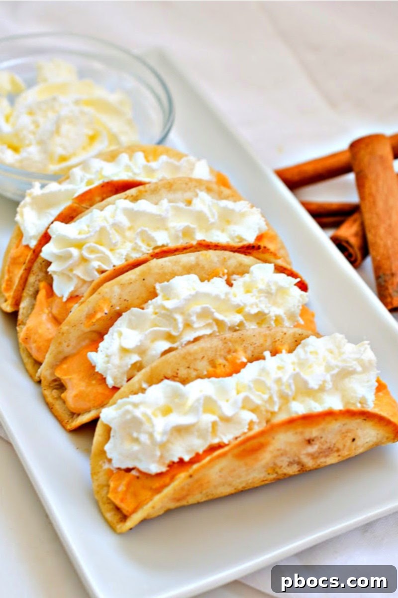 Delicious Keto Pumpkin Pie Tacos served on a white plate, garnished with whipped cream and a sprinkle of cinnamon.