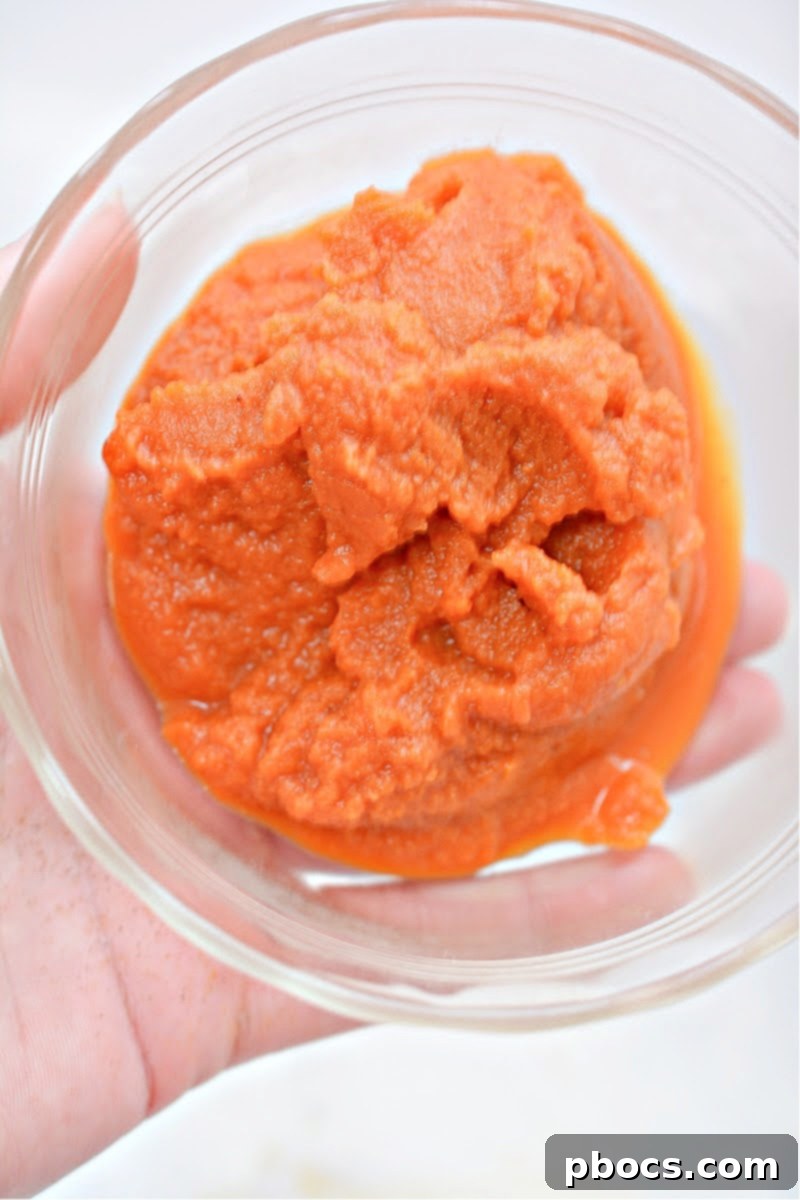 A bowl of creamy pumpkin puree, ready to be mixed into the filling.