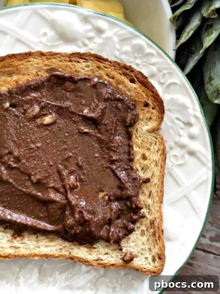 LÄRA Chocolate Coconut Nut Butter being generously spread on a piece of toasted bread