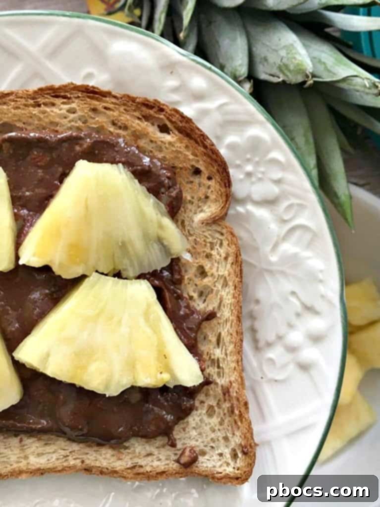 Fresh pineapple chunks placed on Chocolate Coconut & Pineapple Toast, ready for cinnamon