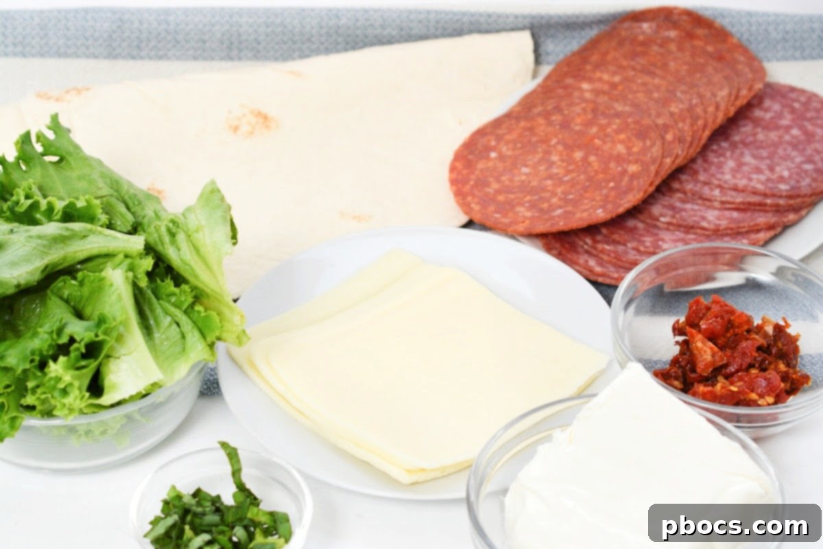 Keto Italian Swirls 9 All ingredients laid out for making Keto Italian Pinwheels, including tortillas, cream cheese, basil, and meats.