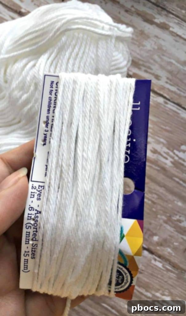 Wrapping white yarn around cardboard for a ghost body