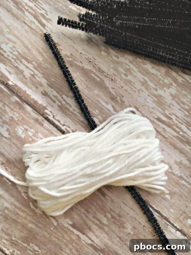 Yarn removed from cardboard and tied with a pipe cleaner for a ghost