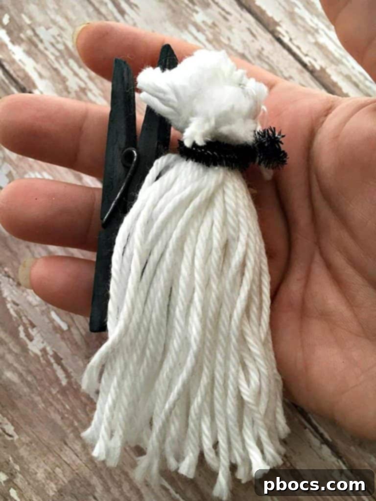 Finished pom pom Halloween decorations with clothespins