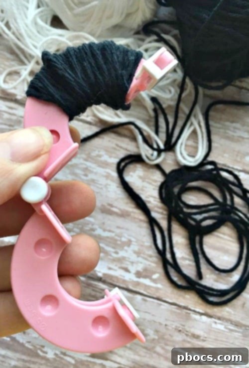 Yarn wrapped on a pom pom maker, ready for cutting