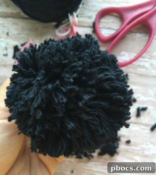 The completed pom pom released from the maker