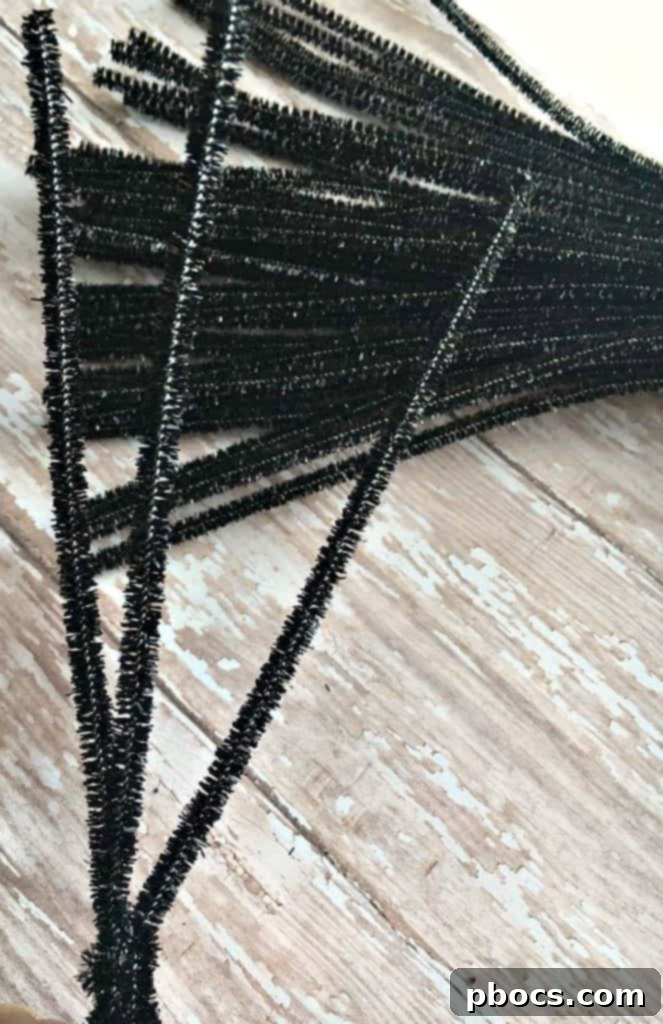 Assembling a DIY pom pom spider with pipe cleaner legs