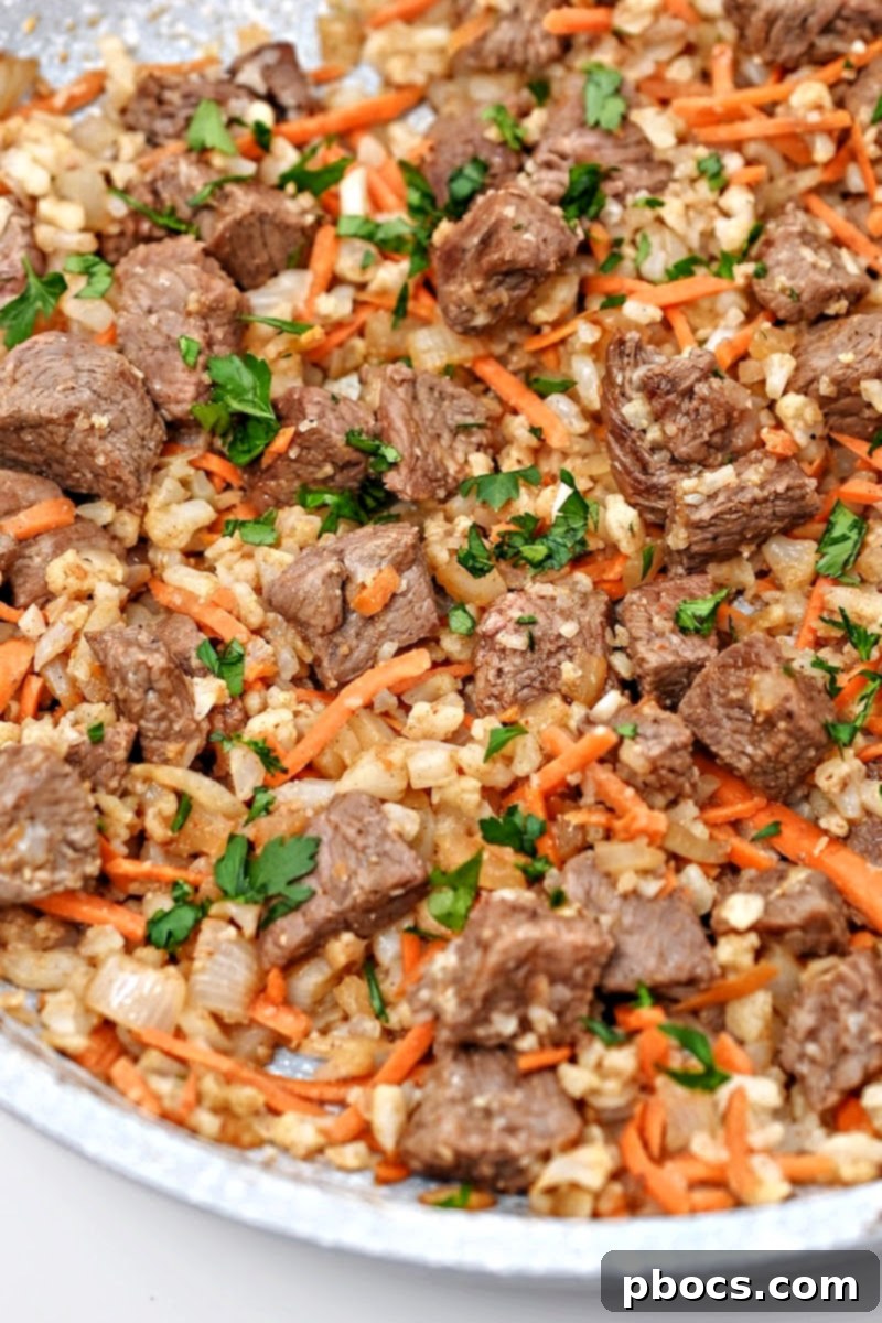 Skillet filled with freshly cooked Low-Carb Beef Cauliflower Rice Pilaf