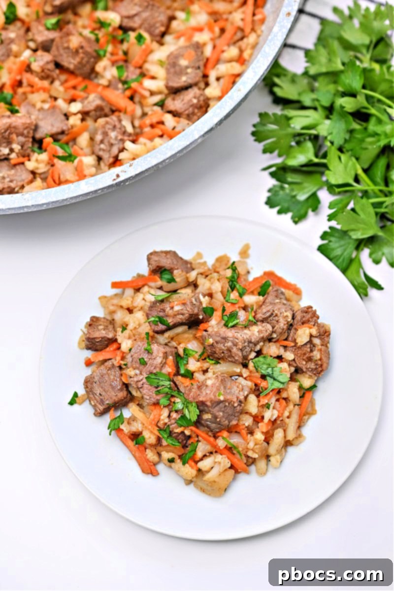 A serving of Low-Carb Beef Cauliflower Rice Pilaf on a plate, ready to be enjoyed