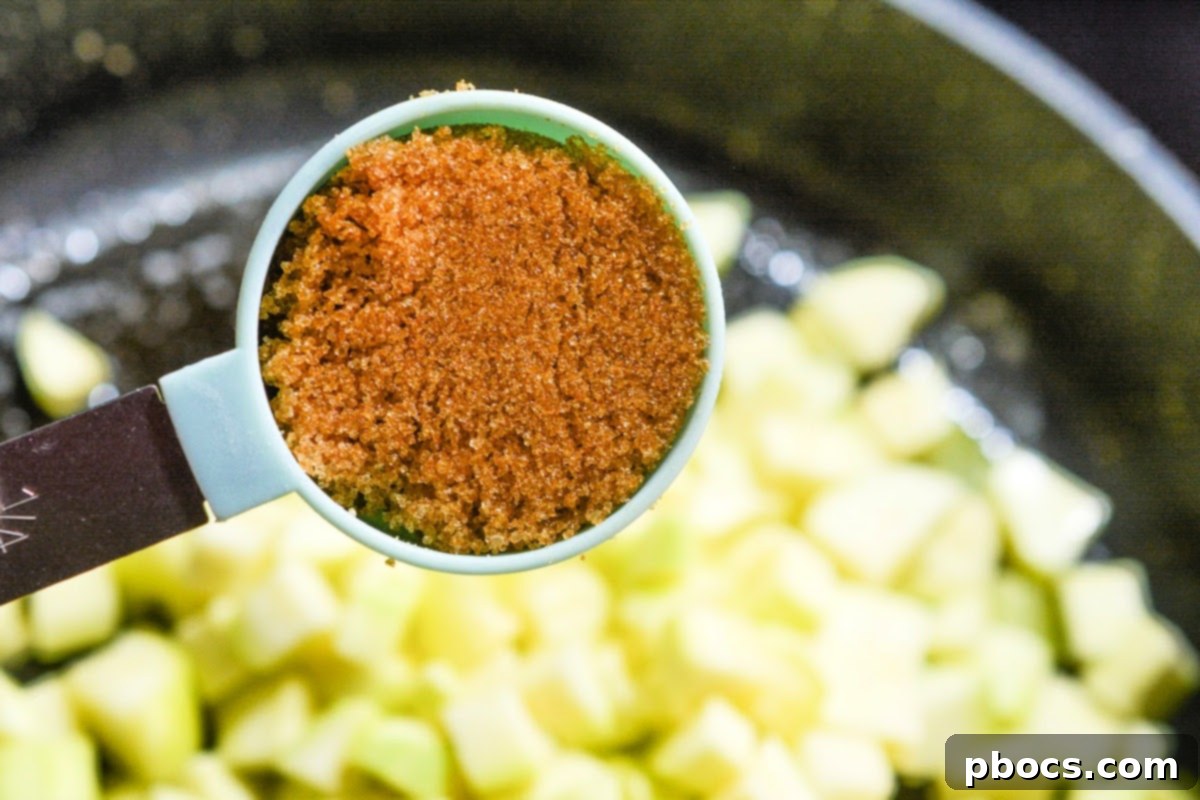 A close-up of Swerve Brown Sugar Substitute in a measuring spoon, highlighting its texture.