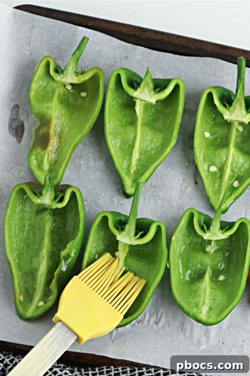Brushing hollowed and halved poblano peppers with butter