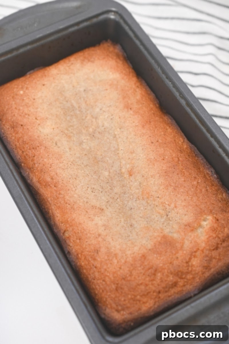 The Keto Starbucks Gingerbread Loaf, golden brown and fresh out of the oven, cooling in its pan.