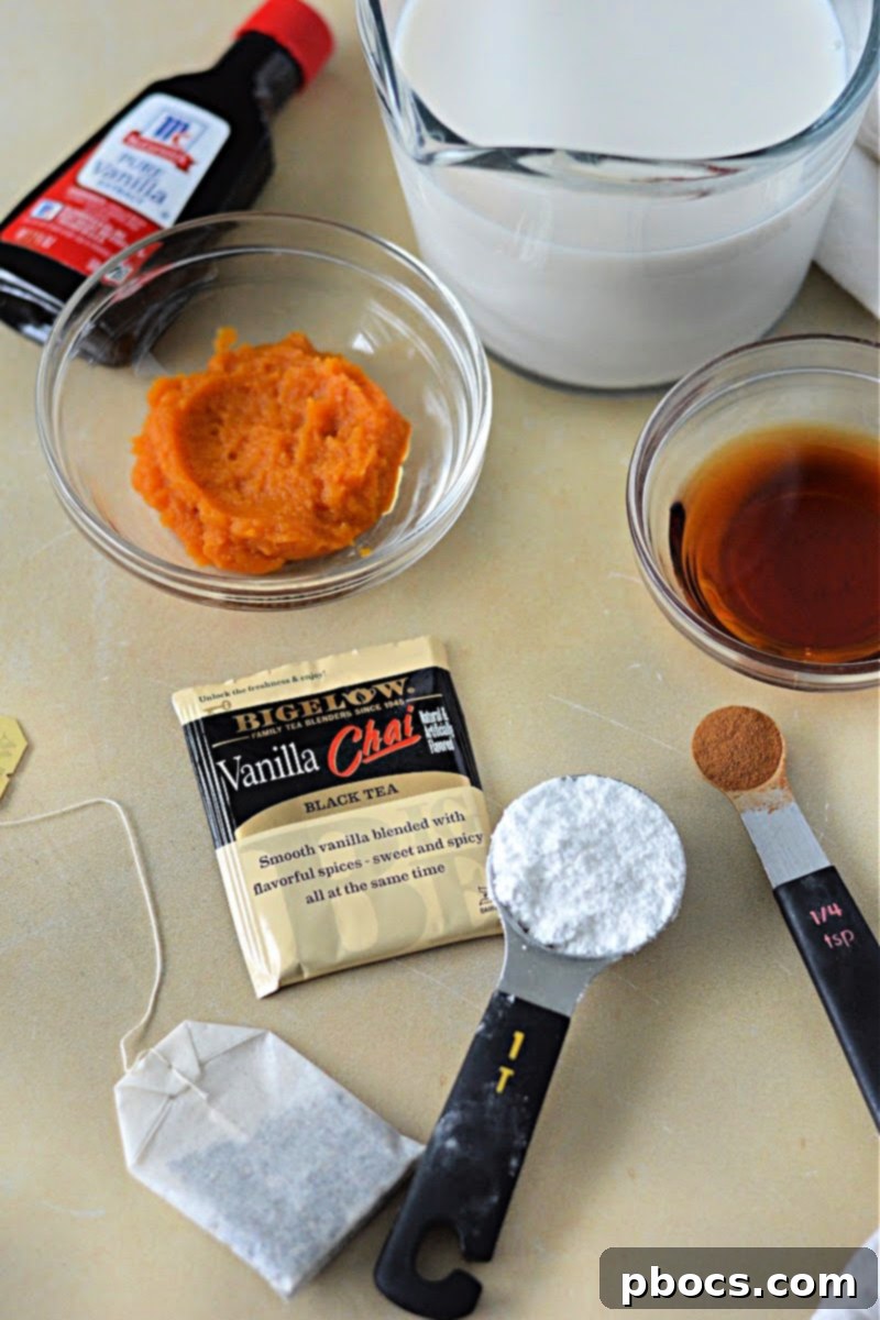 The ingredients for the Keto Pumpkin Chai Tea Latte including almond milk, pumpkin puree, and spices.