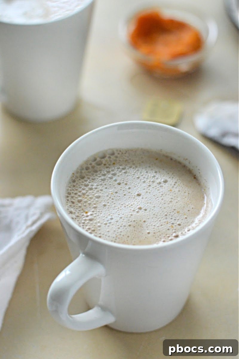 Two glasses of Keto Pumpkin Chai Tea Latte with whipped cream and spices, ready for serving at a brunch.
