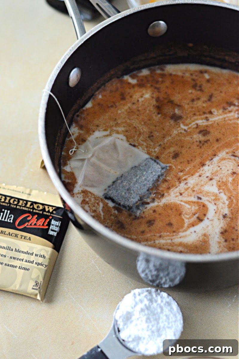 The pumpkin chai tea mixture simmering gently in a pot on the stove.