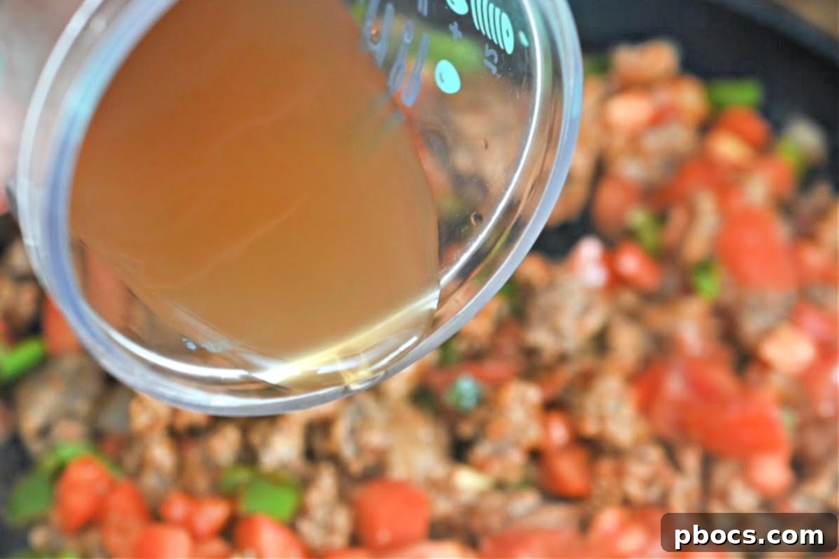 Adding spices and vegetables to chili