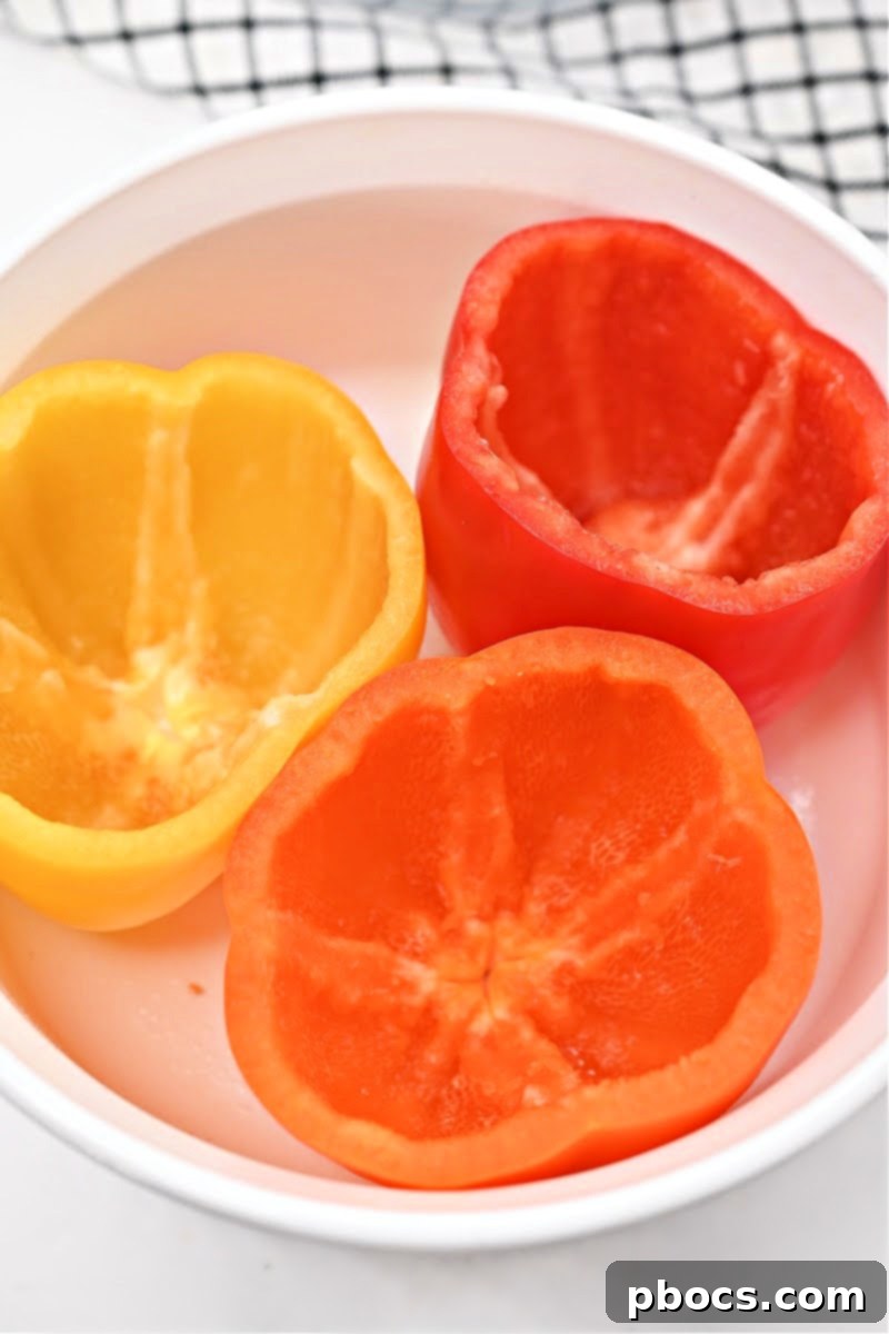 Preparing bell peppers for stuffing: cutting tops and removing seeds
