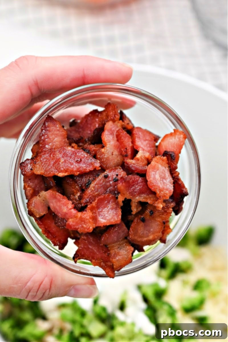 Bell peppers rubbed with olive oil and placed in a baking dish, ready for initial bake