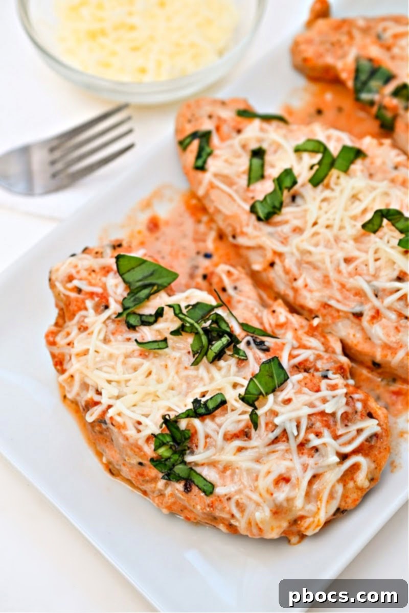 Keto Crockpot Tomato Alfredo Chicken, tender chicken simmered in marinara sauce.