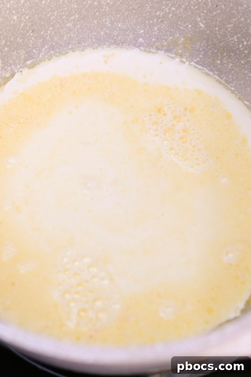 Keto Crockpot Tomato Alfredo Chicken, melting butter.