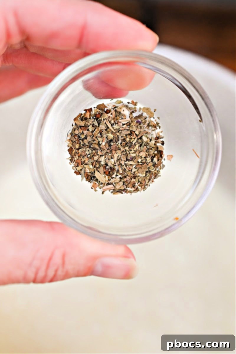 Keto Crockpot Tomato Alfredo Chicken, adding heavy cream.