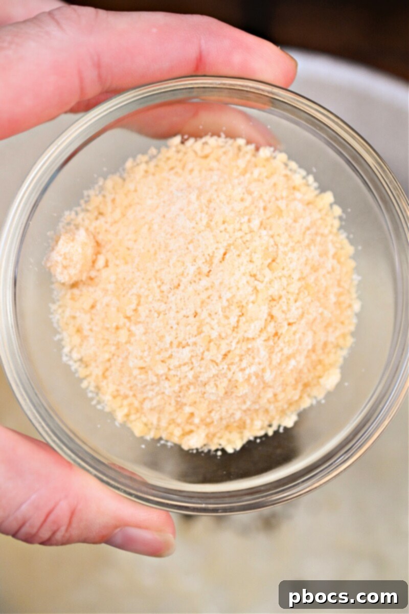 Keto Crockpot Tomato Alfredo Chicken, simmering sauce with basil.