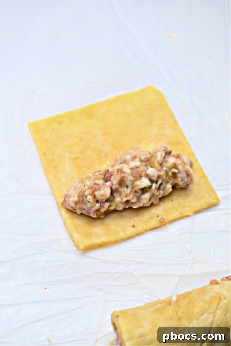 Fathead dough rolled out and cut into squares on parchment paper