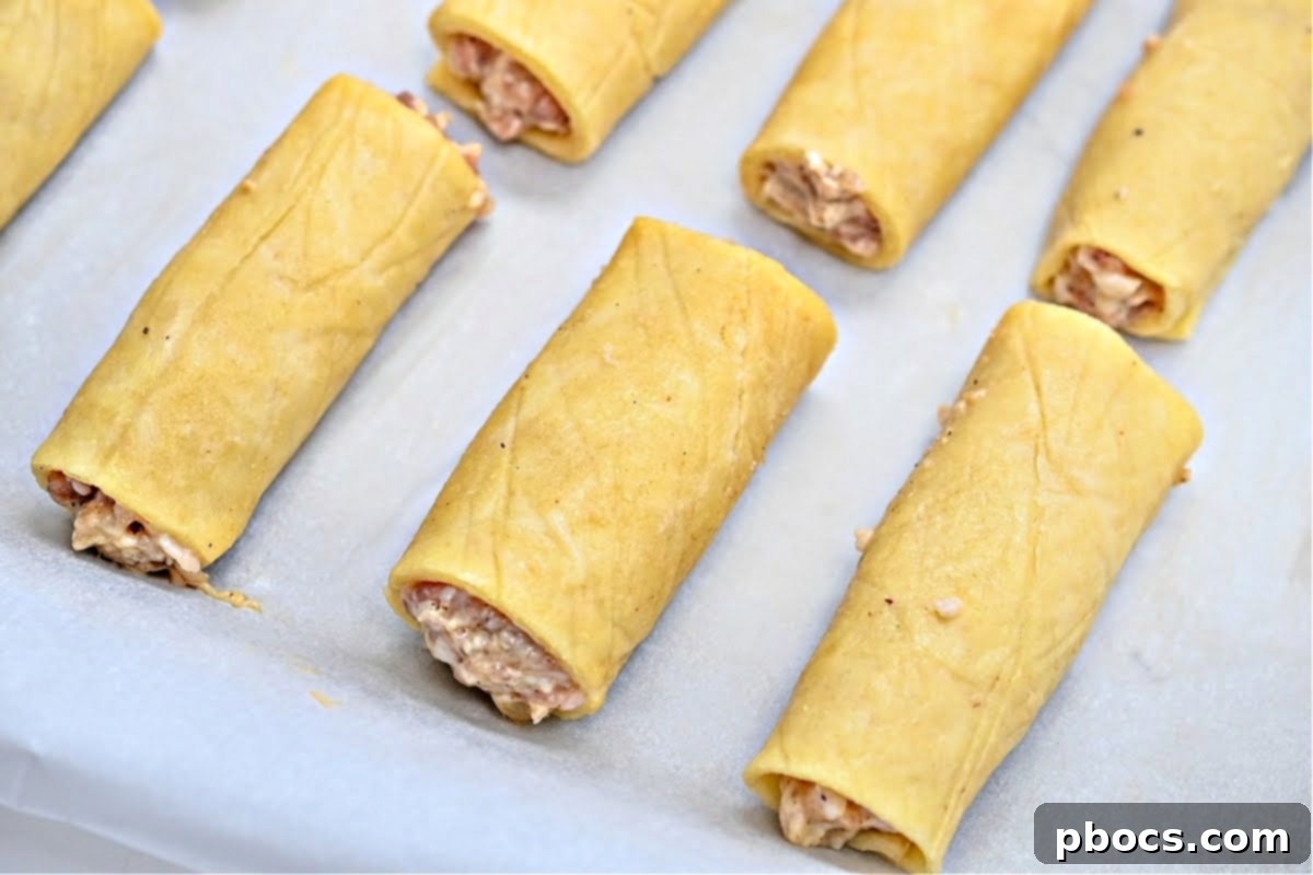 Sausage filling placed on dough, ready to be rolled