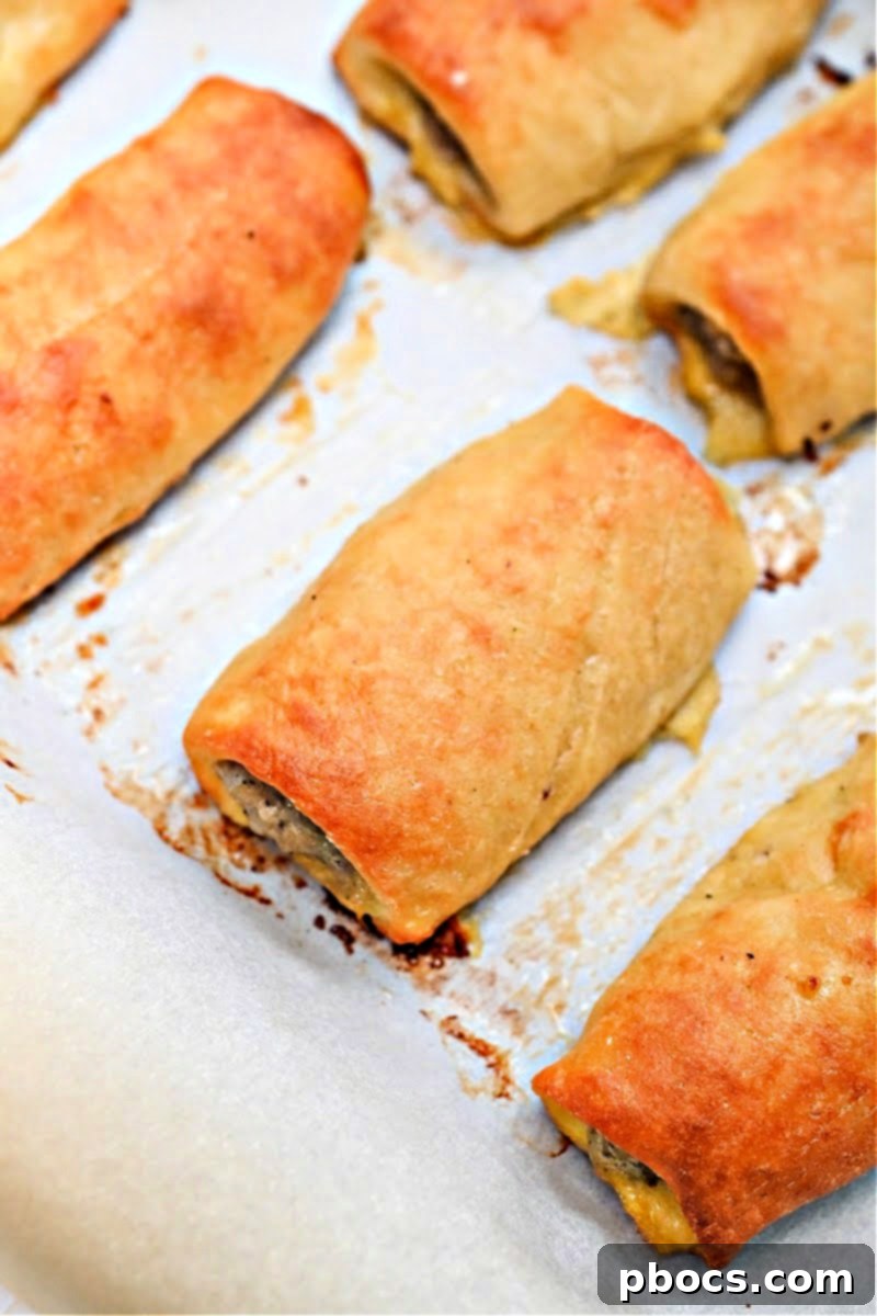 Baked golden brown Keto Sausage Rolls on a baking sheet