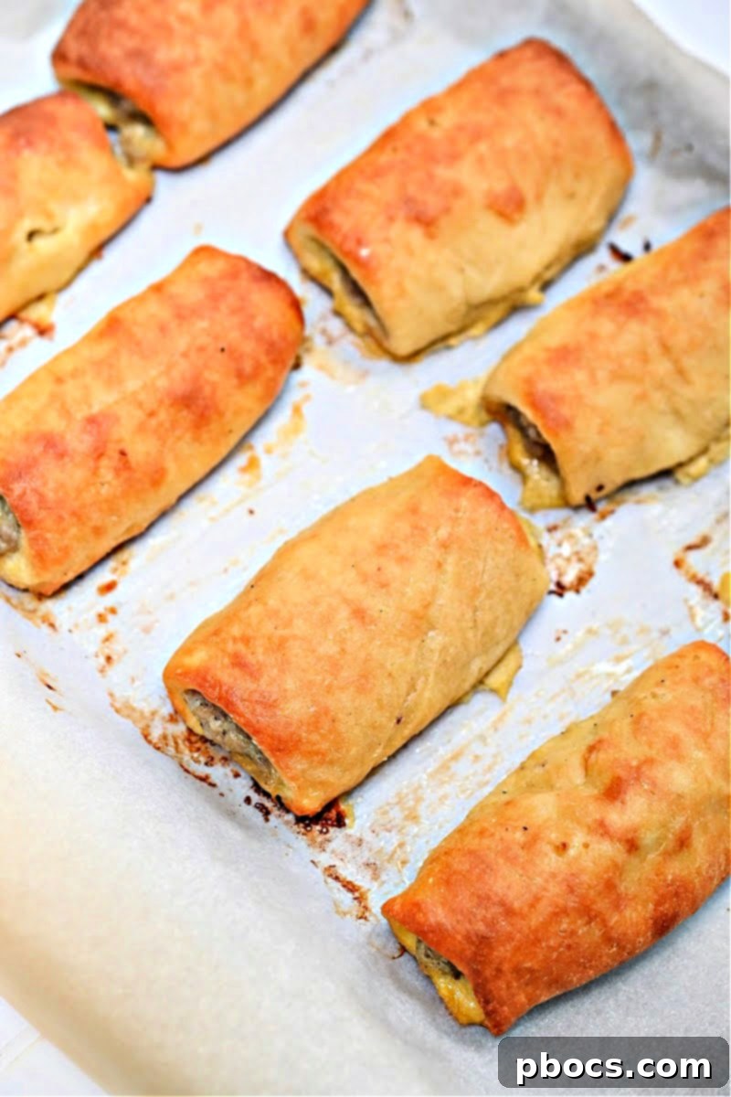 Hand holding a freshly baked Keto Sausage Roll