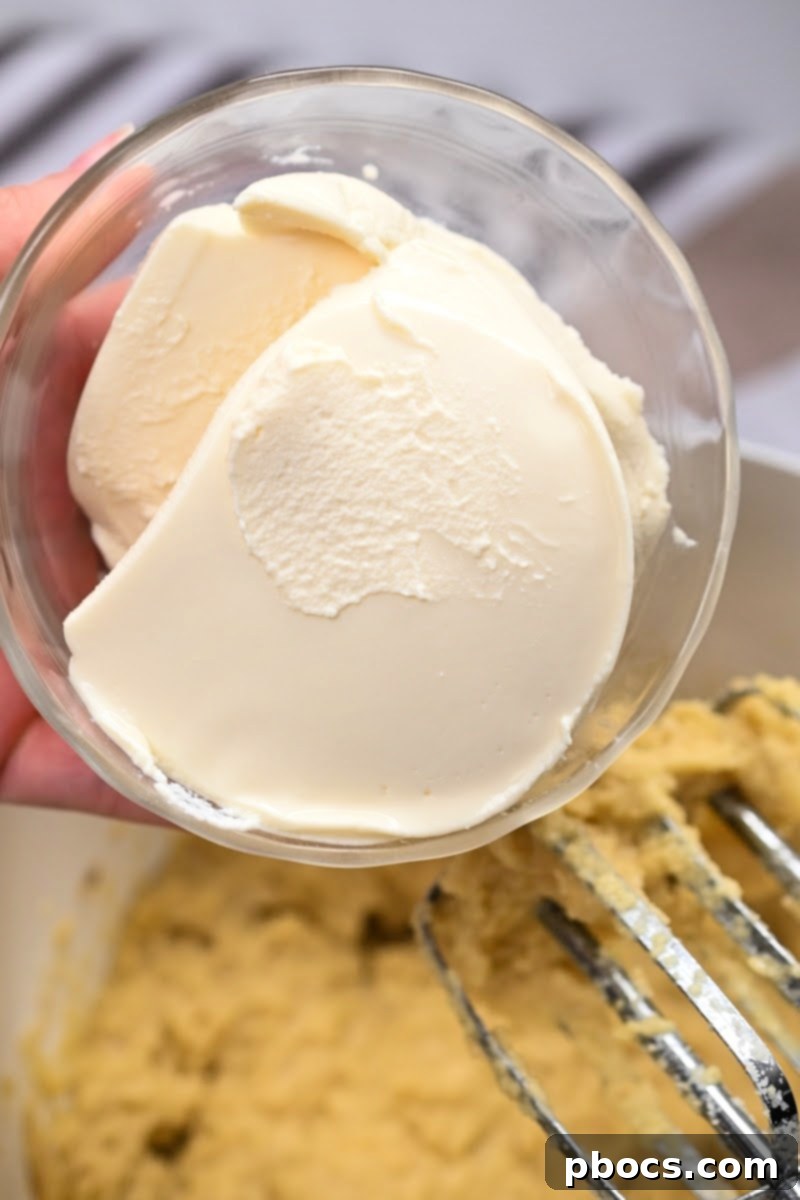 Creamy Low-Carb Ricotta Banana Bread 10 Close-up of ricotta cheese being added to banana bread batter