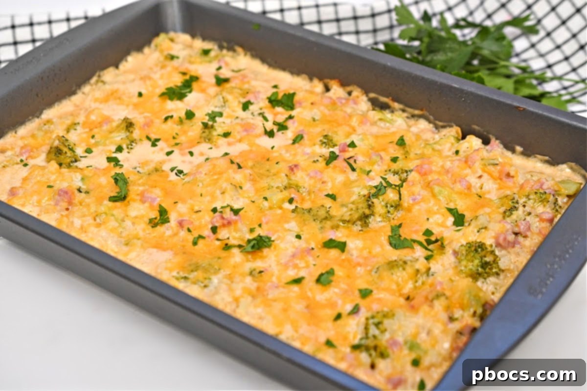 Cheesy Low-Carb Broccoli Rice Casserole With Ham on a blue dish
