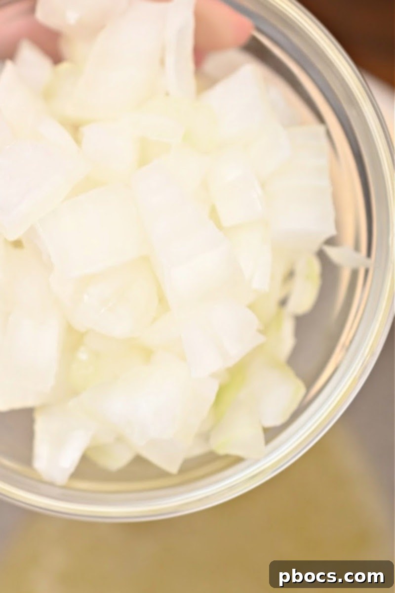 Sautéing onions in butter for cheesy ham broccoli rice casserole