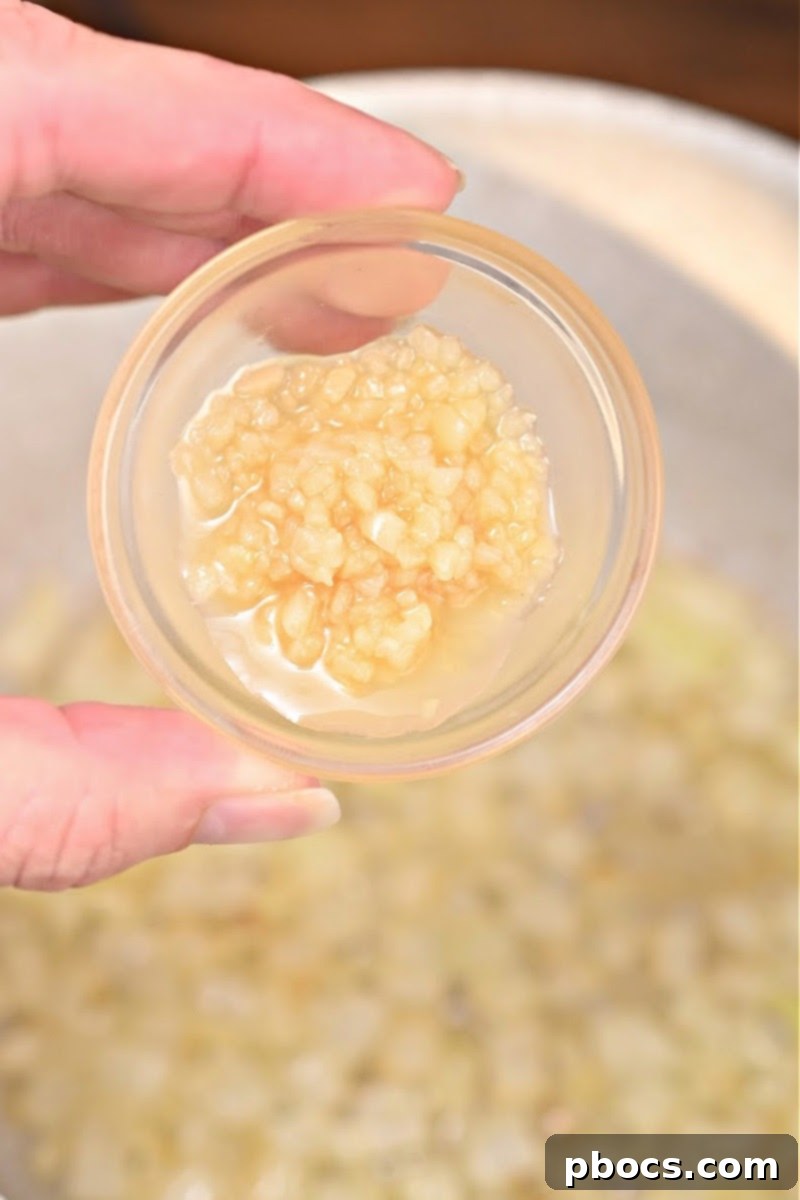 Onions sautéing for cheesy ham broccoli rice casserole