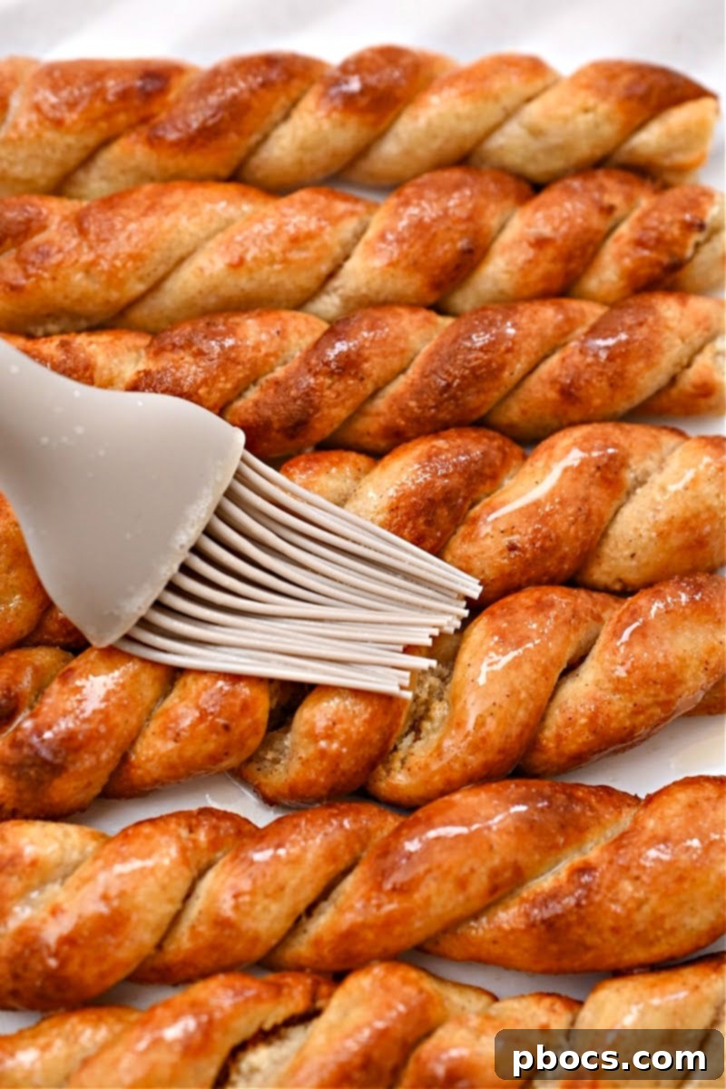 Sweet Keto Cinnamon Air Fryer Twirls 15 Applying Cinnamon Sugar to Twists