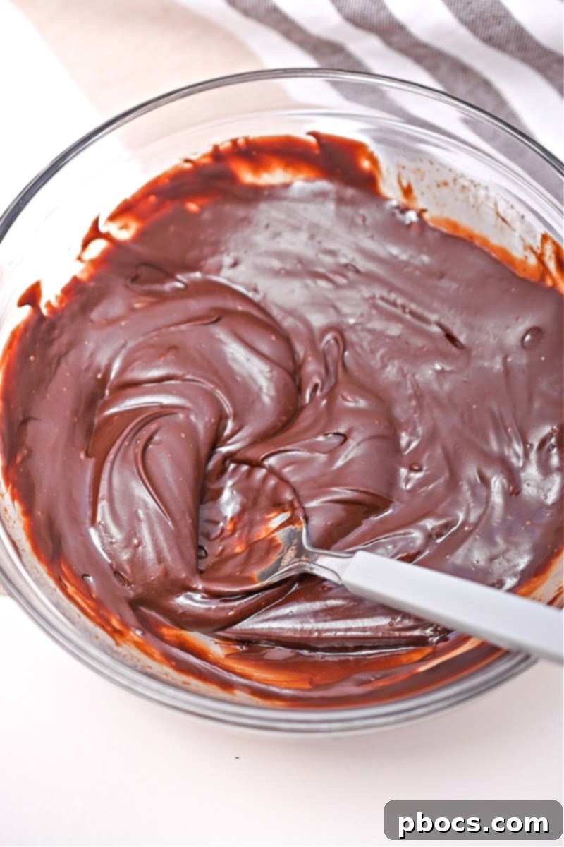 Keto No-Bake Death By Chocolate Cheesecake Bars 11 Melting chocolate chips with heavy whipping cream