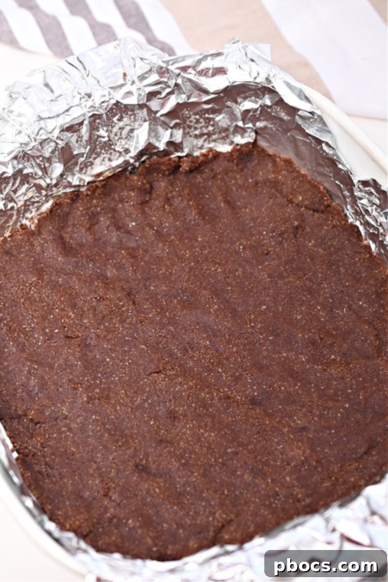 Keto No-Bake Death By Chocolate Cheesecake Bars 9 Lining a baking dish with aluminum foil