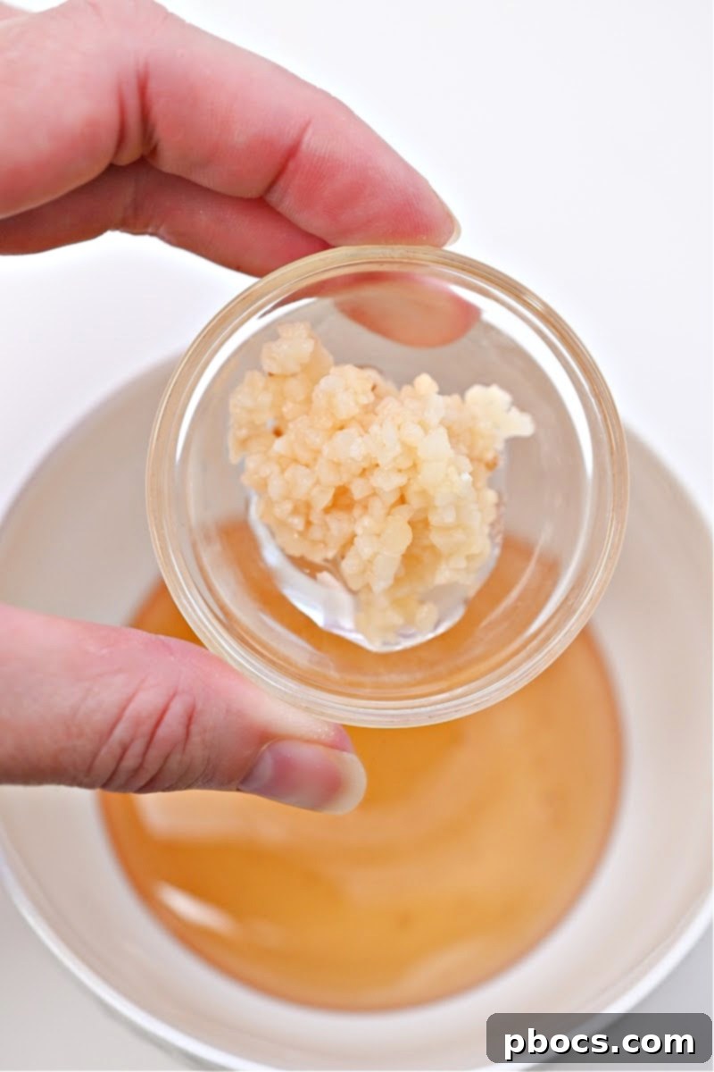 A small bowl of minced garlic, ready to be mixed into the honey garlic sauce.