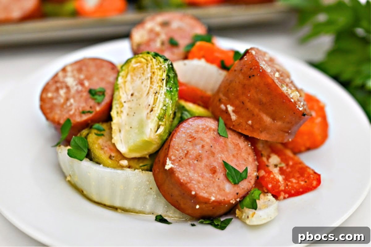 A perfectly cooked Low Carb Honey Garlic Sausage and Veggies sheet pan meal, served on a white plate, highlighting the delicious glaze and tender ingredients.