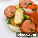 A white plate of Low Carb Honey Garlic Sausage and Veggies, presented as a delicious and healthy meal.