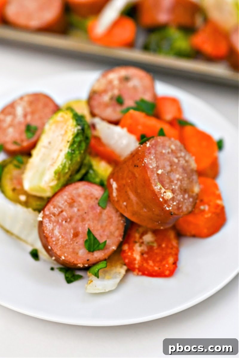 A white plate showcasing the finished Low Carb Honey Garlic Sausage and Veggies, garnished and ready to eat.