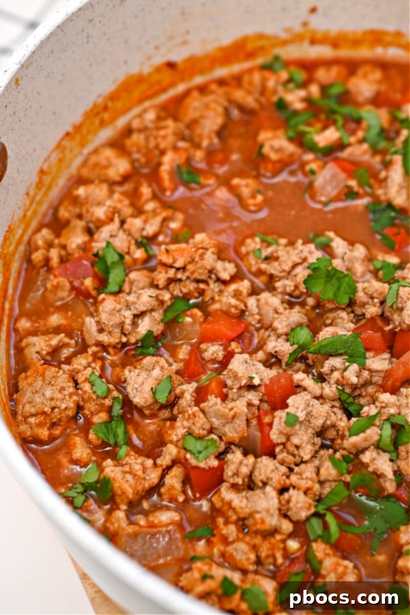 A bowl of Keto Pumpkin Chili ready to be served with delicious sides