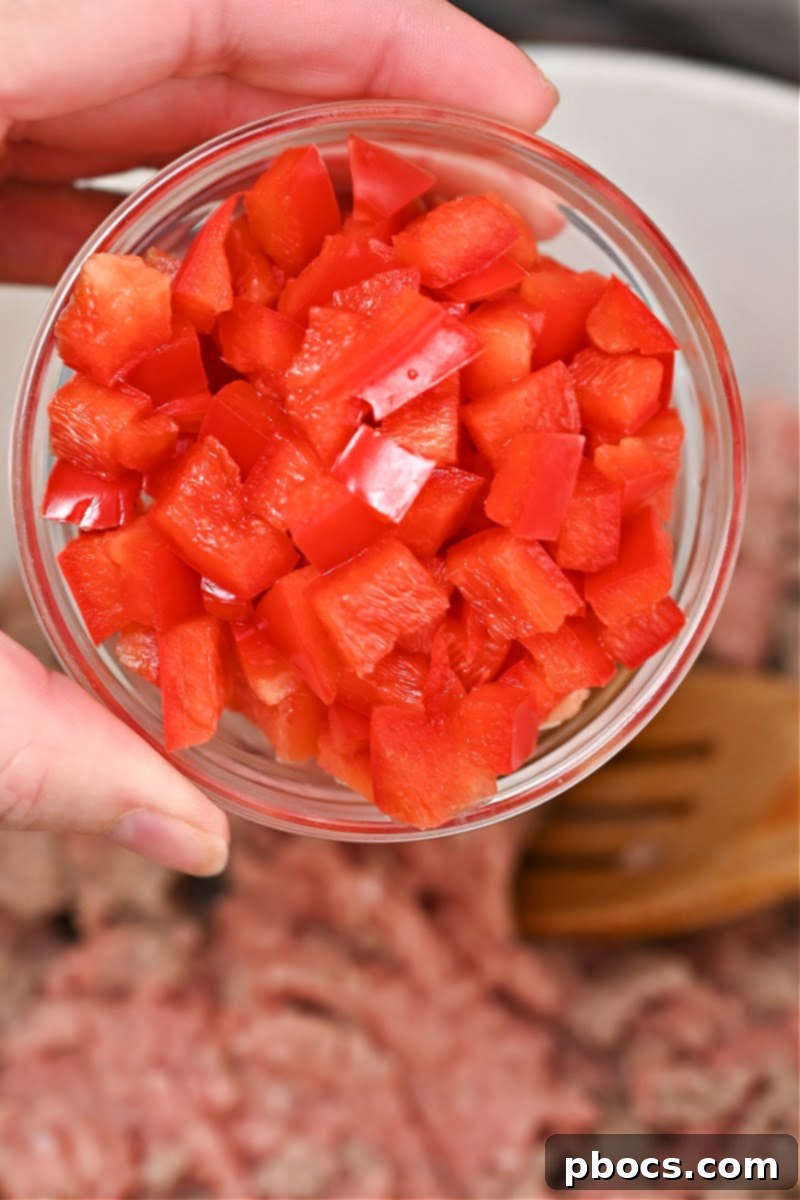 Ground turkey, onion, and bell pepper cooking in a pot for chili