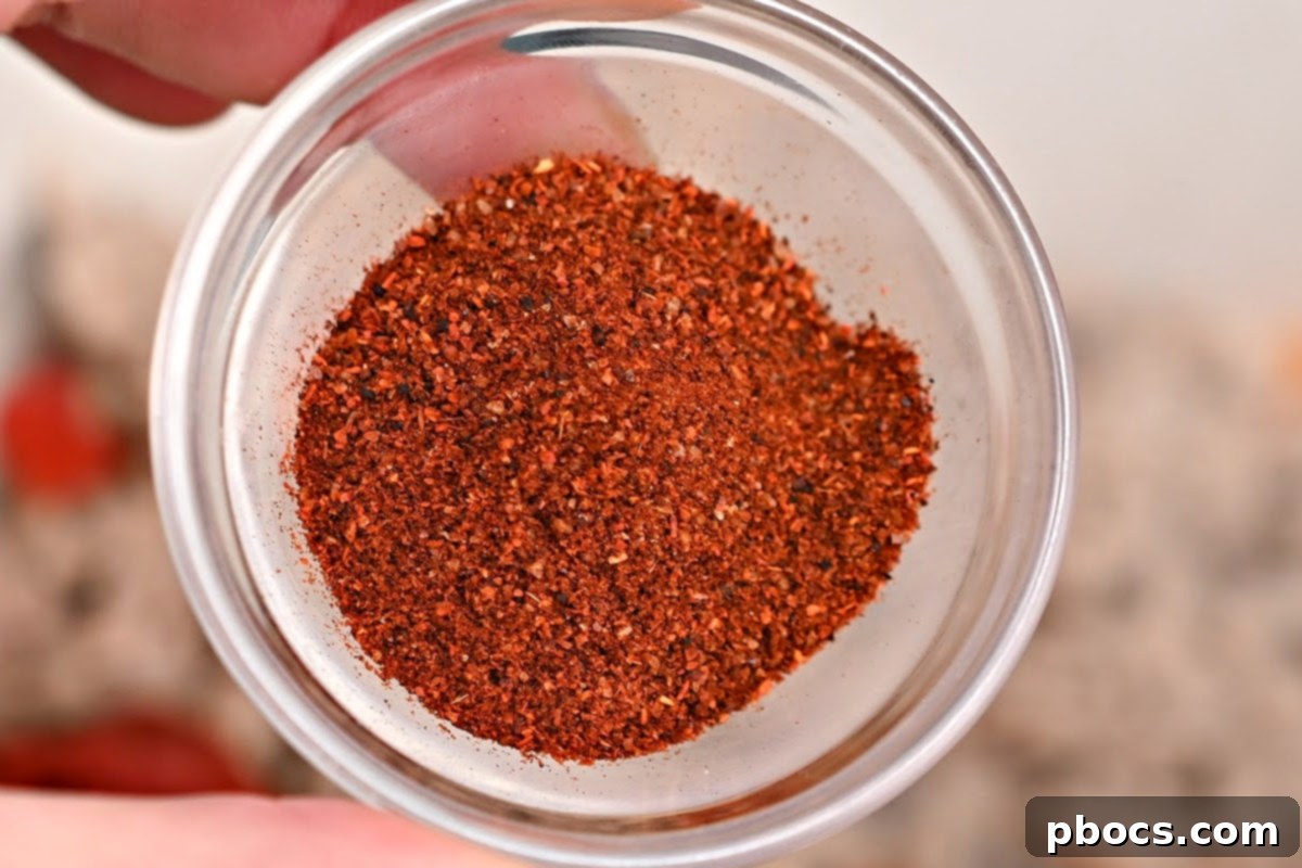 Close-up of chili seasoning being added to the pot