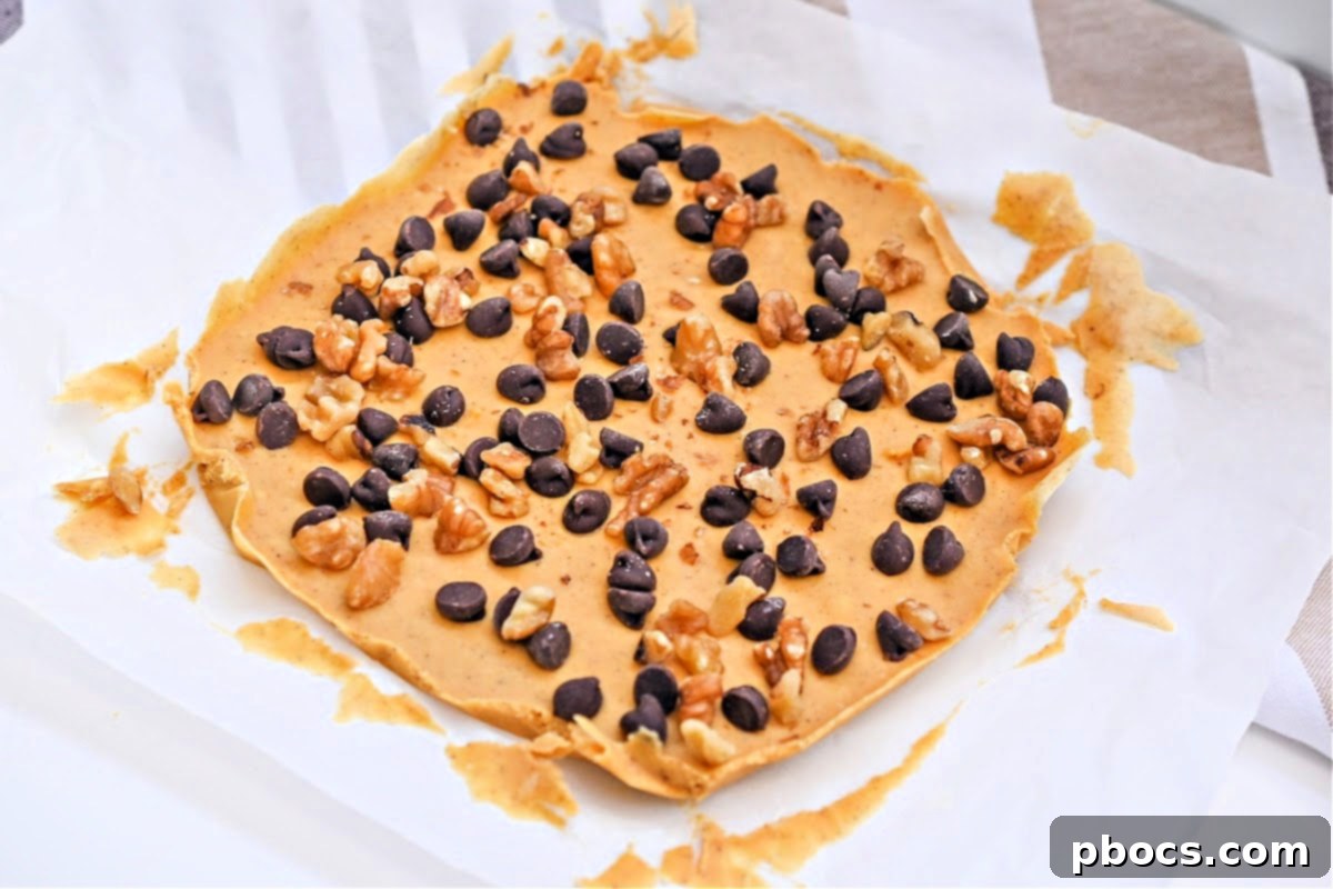 Pulling the set fudge off the parchment paper, ready for slicing
