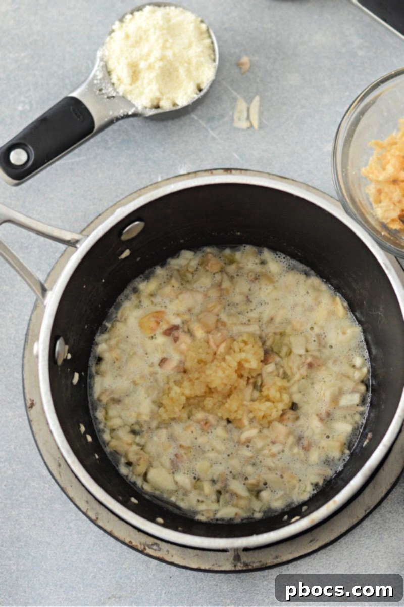 Adding garlic to the sauce.