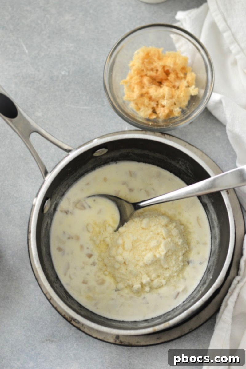 Making the cream sauce in a saucepan.