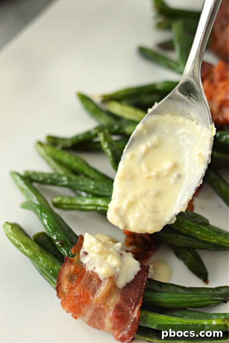 Adding the creamy sauce on top of the bacon wrapped green beans.